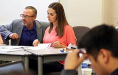 Student working with professor in class